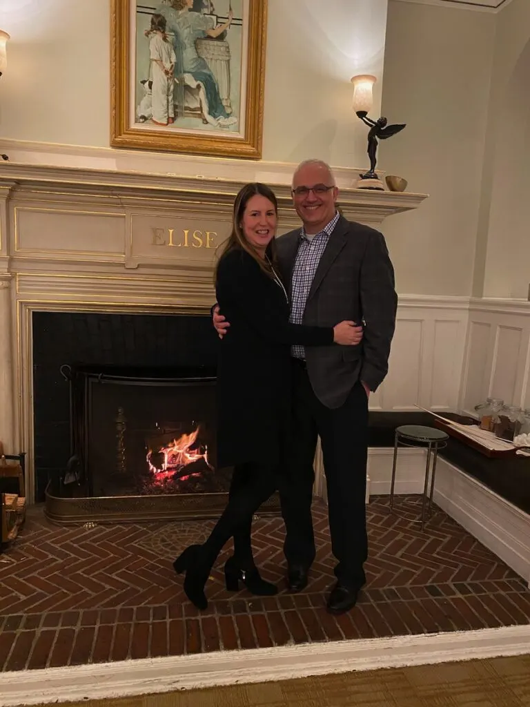 Glenn and Tamara in front of the fireplace at The Vanderbilt Hotel Newport