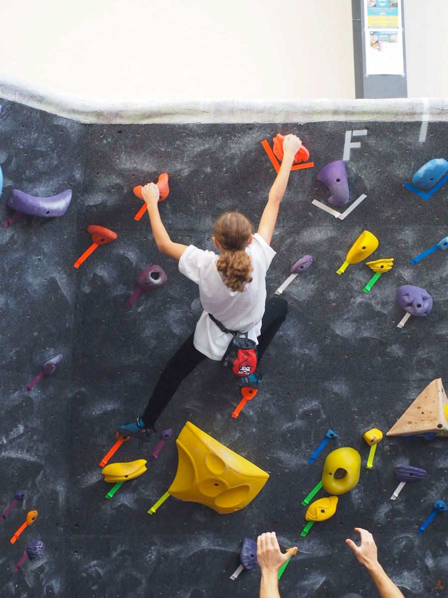 Girl rock climbing on wall