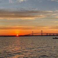 Pell Bridge at sunset with boat in the foreground - Rhode Island sunsets